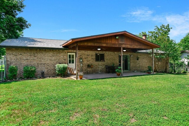 304 White Wing Way, Round Rock, TX 78664 - rear view of property featuring a yard, brick siding, a patio area, and a ceiling fan