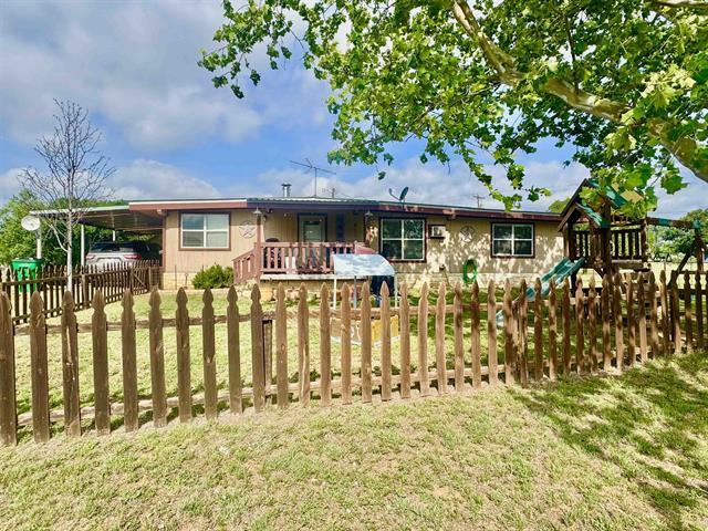 1415 Bee Ln, Tow, TX 78672 - back of house featuring a playground, an attached carport, and driveway