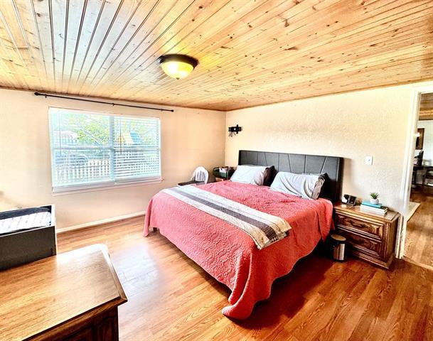 1415 Bee Ln, Tow, TX 78672 - bedroom with wooden ceiling and wood finished floors