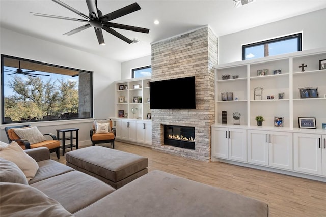 335 Sandy Mountain Dr, Sunrise Beach, TX 78643 - living area with a ceiling fan, light wood-style flooring, a large fireplace, and recessed lighting