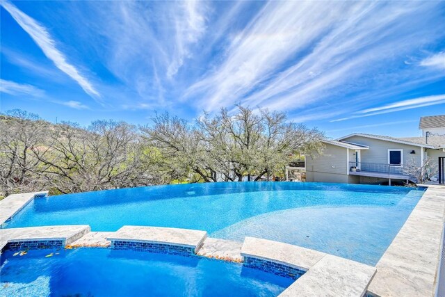 335 Sandy Mountain Dr, Sunrise Beach, TX 78643 - view of swimming pool featuring a pool with connected hot tub