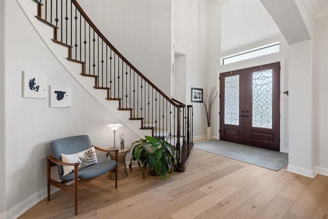 1501 University Club Dr, Austin, TX 78732 - entrance foyer with wood finished floors, stairs, baseboards, a high ceiling, and french doors