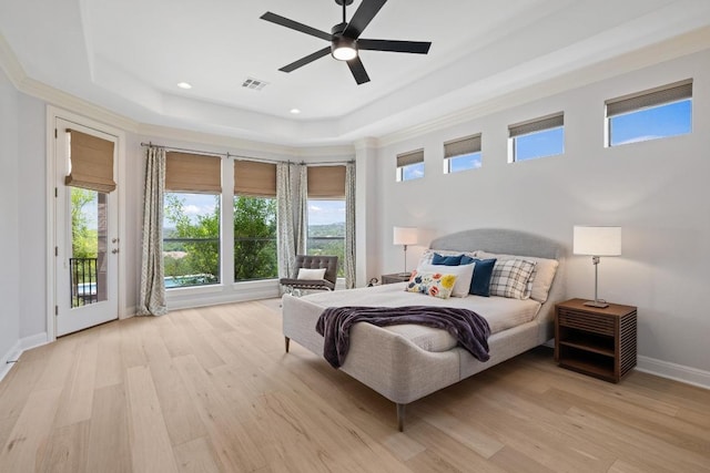 1501 University Club Dr, Austin, TX 78732 - bedroom with a tray ceiling, access to exterior, light wood-style flooring, multiple windows, and recessed lighting