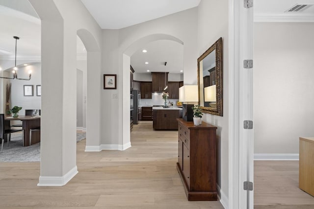 1501 University Club Dr, Austin, TX 78732 - foyer with light wood-style floors, baseboards, arched walkways, and recessed lighting