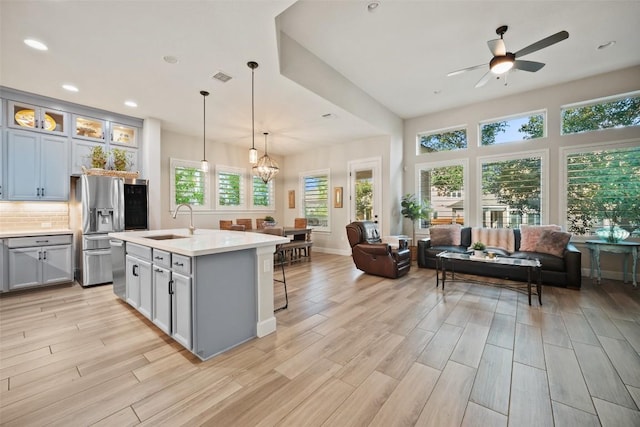 5820 Harper Park Dr Unit 66, Austin, TX 78735 - kitchen with stainless steel fridge with ice dispenser, a sink, light countertops, a ceiling fan, and open floor plan