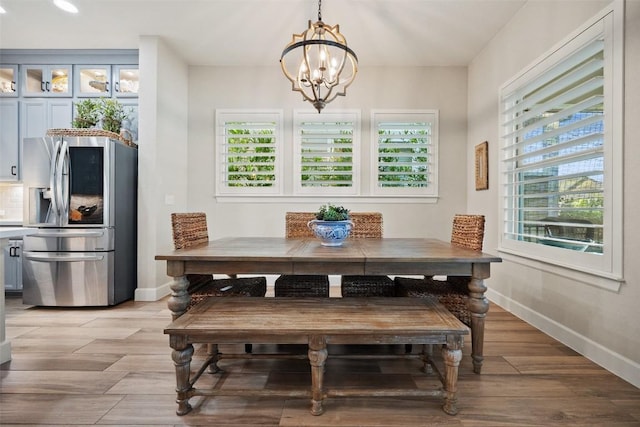 5820 Harper Park Dr Unit 66, Austin, TX 78735 - dining space featuring a chandelier, recessed lighting, baseboards, and light wood finished floors