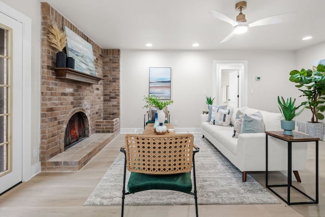 13322 Villa Park Dr, Austin, TX 78729 - living area featuring wood finished floors, recessed lighting, a brick fireplace, and ceiling fan
