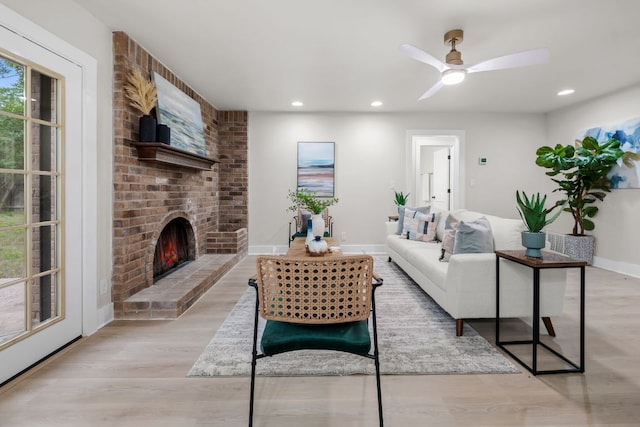 13322 Villa Park Dr, Austin, TX 78729 - living area featuring light wood-style floors, recessed lighting, a fireplace, baseboards, and a ceiling fan