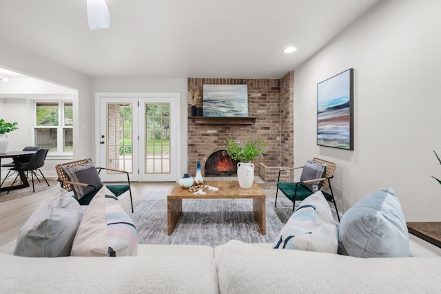 13322 Villa Park Dr, Austin, TX 78729 - living area with wood finished floors, a brick fireplace, and recessed lighting