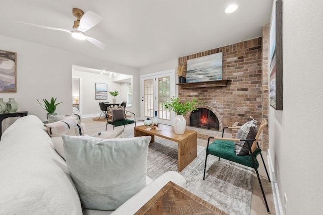 13322 Villa Park Dr, Austin, TX 78729 - living room with wood finished floors, a brick fireplace, ceiling fan, and baseboards