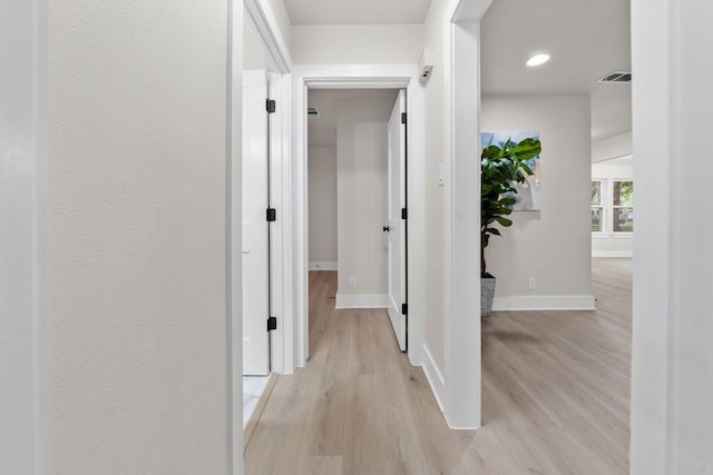 13322 Villa Park Dr, Austin, TX 78729 - corridor with light wood-style flooring, baseboards, and recessed lighting