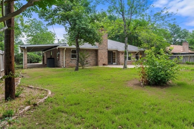 13322 Villa Park Dr, Austin, TX 78729 - back of house with brick siding, a chimney, a carport, and central AC