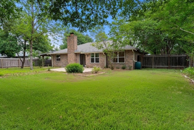 13322 Villa Park Dr, Austin, TX 78729 - back of property with a chimney, a patio area, and brick siding
