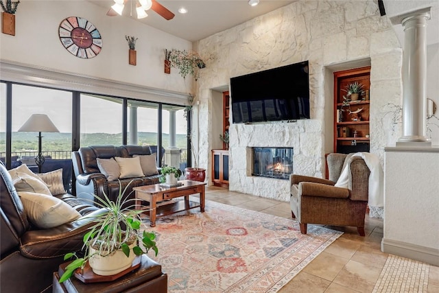 17400 Northlake Hills Dr, Jonestown, TX 78645 - living area featuring decorative columns, tile patterned flooring, a high ceiling, a high end fireplace, and a ceiling fan