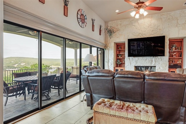 17400 Northlake Hills Dr, Jonestown, TX 78645 - living room with ceiling fan, a fireplace, light tile patterned flooring, and recessed lighting