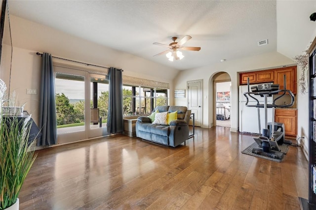 17400 Northlake Hills Dr, Jonestown, TX 78645 - living room featuring a ceiling fan, arched walkways, wood finished floors, and a textured ceiling