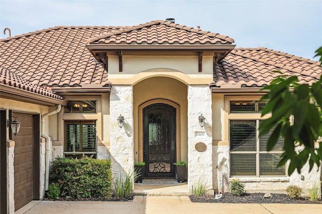 17400 Northlake Hills Dr, Jonestown, TX 78645 - doorway to property featuring a tile roof, stucco siding, and an attached garage