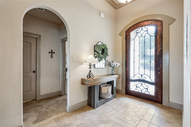 17400 Northlake Hills Dr, Jonestown, TX 78645 - entrance foyer featuring arched walkways, light tile patterned floors, and baseboards
