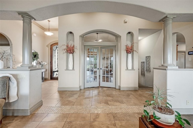 17400 Northlake Hills Dr, Jonestown, TX 78645 - foyer with decorative columns, baseboards, light tile patterned flooring, and crown molding