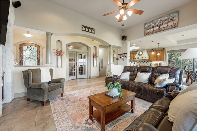 17400 Northlake Hills Dr, Jonestown, TX 78645 - living area featuring arched walkways, decorative columns, ceiling fan, french doors, and light tile patterned floors