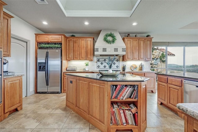 17400 Northlake Hills Dr, Jonestown, TX 78645 - kitchen featuring appliances with stainless steel finishes, custom range hood, backsplash, recessed lighting, and light stone countertops