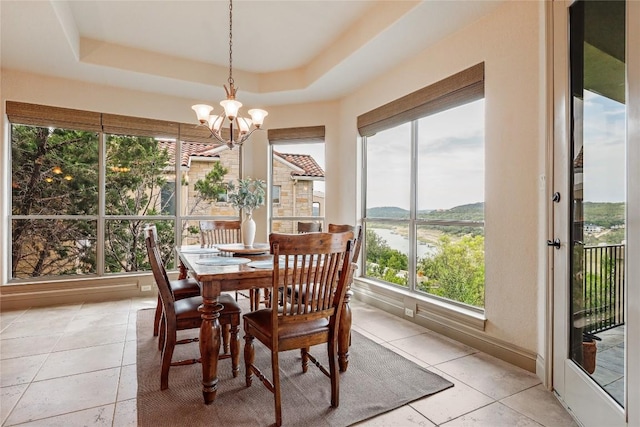 17400 Northlake Hills Dr, Jonestown, TX 78645 - dining space with plenty of natural light, a chandelier, a raised ceiling, and light tile patterned floors