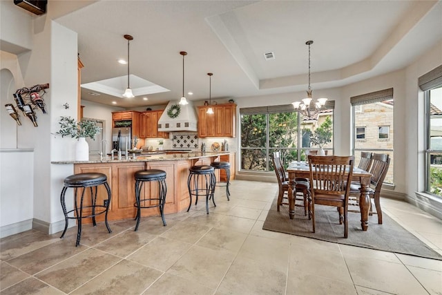 17400 Northlake Hills Dr, Jonestown, TX 78645 - dining area with a raised ceiling, a chandelier, recessed lighting, baseboards, and light tile patterned floors