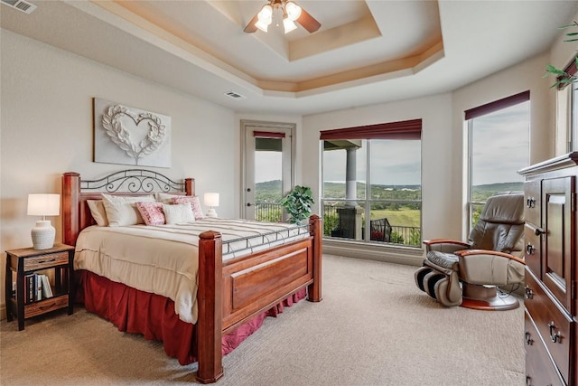 17400 Northlake Hills Dr, Jonestown, TX 78645 - bedroom featuring light carpet, access to exterior, a raised ceiling, and ceiling fan