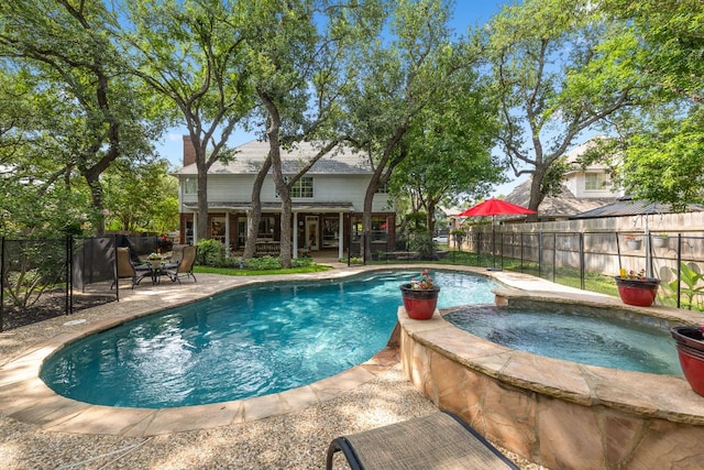 3808 Royal Troon Dr, Round Rock, TX 78664 - view of swimming pool featuring a fenced backyard, a patio, and a pool with connected hot tub