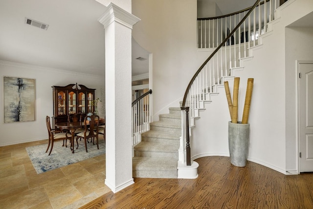 3808 Royal Troon Dr, Round Rock, TX 78664 - staircase featuring baseboards, crown molding, a towering ceiling, and ornate columns
