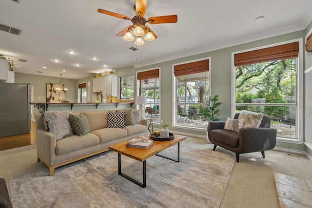 3808 Royal Troon Dr, Round Rock, TX 78664 - living room with plenty of natural light, a ceiling fan, crown molding, baseboards, and light colored carpet