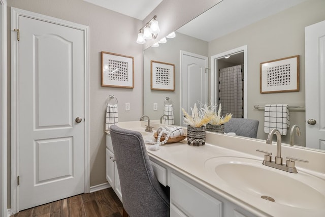 3808 Royal Troon Dr, Round Rock, TX 78664 - full bath featuring double vanity, wood finished floors, and baseboards