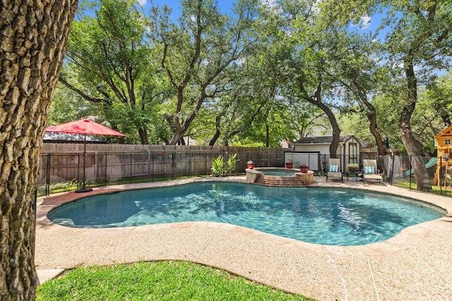 3808 Royal Troon Dr, Round Rock, TX 78664 - view of pool with a fenced backyard, a playground, a pool with connected hot tub, and a patio