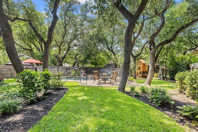 3808 Royal Troon Dr, Round Rock, TX 78664 - fenced backyard with a playground and a patio