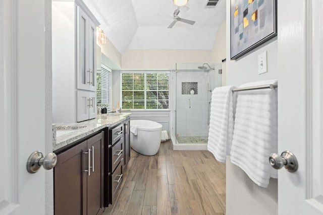 3808 Royal Troon Dr, Round Rock, TX 78664 - bathroom featuring a stall shower, vanity, a ceiling fan, a freestanding tub, and wood finished floors