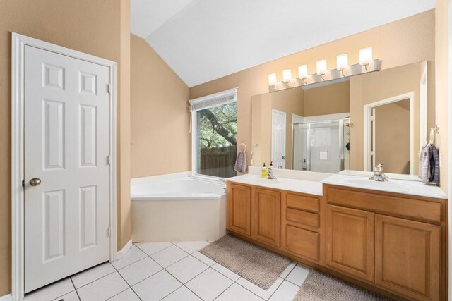 10609 Thoroughbred Dr, Austin, TX 78748 - full bathroom with a stall shower, double vanity, a bath, lofted ceiling, and tile patterned flooring