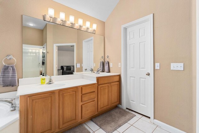 10609 Thoroughbred Dr, Austin, TX 78748 - bathroom featuring double vanity, tile patterned flooring, vaulted ceiling, a bath, and a shower with shower door