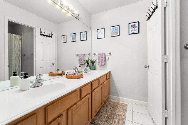 10609 Thoroughbred Dr, Austin, TX 78748 - bathroom featuring double vanity, tile patterned flooring, and baseboards