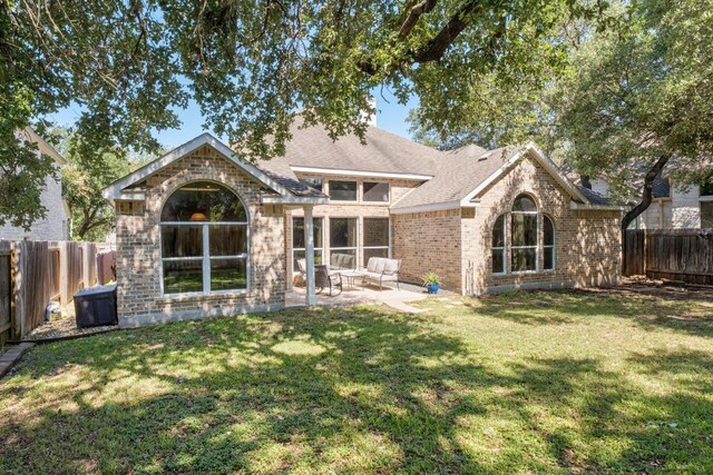 10609 Thoroughbred Dr, Austin, TX 78748 - back of property featuring brick siding, a patio area, and roof with shingles