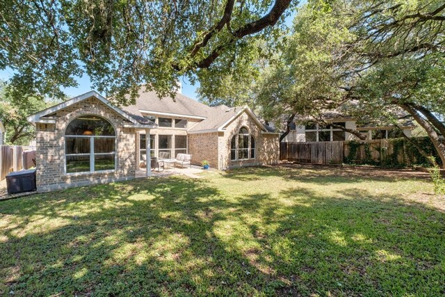 10609 Thoroughbred Dr, Austin, TX 78748 - rear view of property with a patio area and brick siding