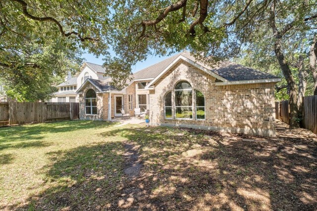 10609 Thoroughbred Dr, Austin, TX 78748 - rear view of house featuring brick siding and roof with shingles