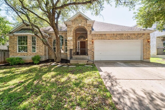 10609 Thoroughbred Dr, Austin, TX 78748 - traditional-style house featuring brick siding, a garage, and concrete driveway