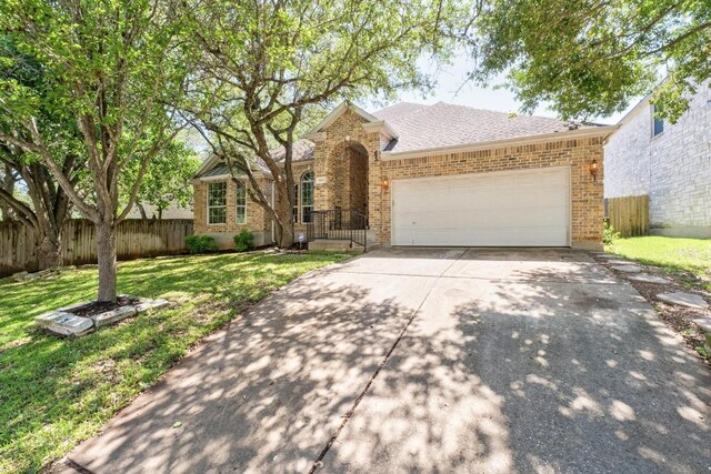 10609 Thoroughbred Dr, Austin, TX 78748 - traditional home featuring brick siding, concrete driveway, an attached garage, and roof with shingles