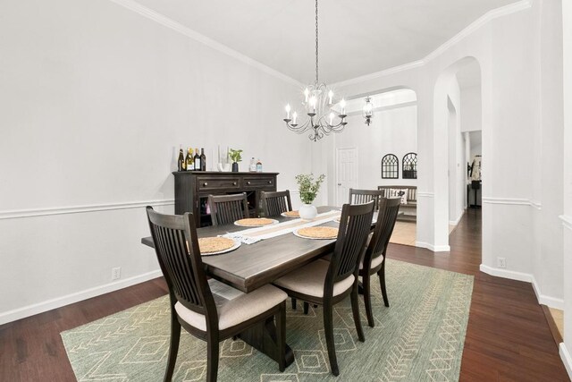 10609 Thoroughbred Dr, Austin, TX 78748 - dining area featuring a chandelier, wood finished floors, arched walkways, baseboards, and ornamental molding