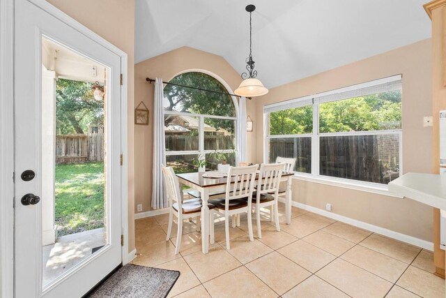 10609 Thoroughbred Dr, Austin, TX 78748 - dining room featuring light tile patterned flooring, lofted ceiling, and baseboards