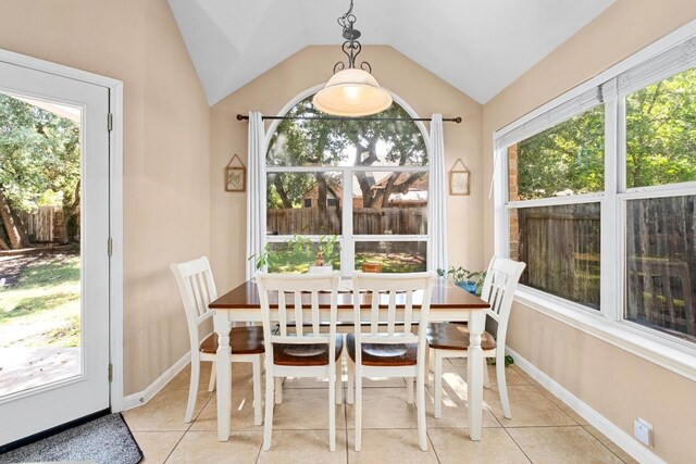 10609 Thoroughbred Dr, Austin, TX 78748 - dining area featuring light tile patterned floors, vaulted ceiling, and baseboards