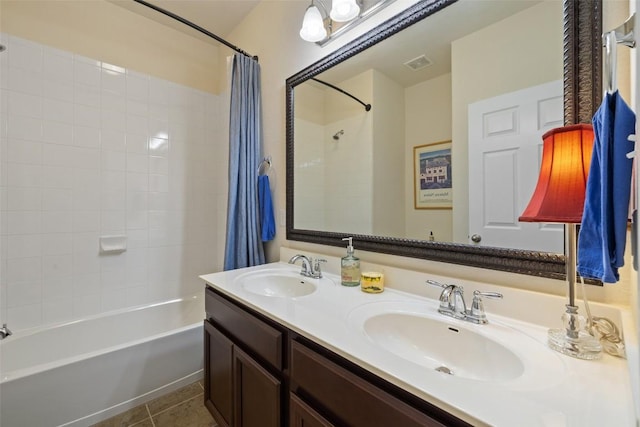 1049 Naranjo Dr, Georgetown, TX 78628 - bathroom featuring shower / bathtub combination with curtain, double vanity, and tile patterned flooring