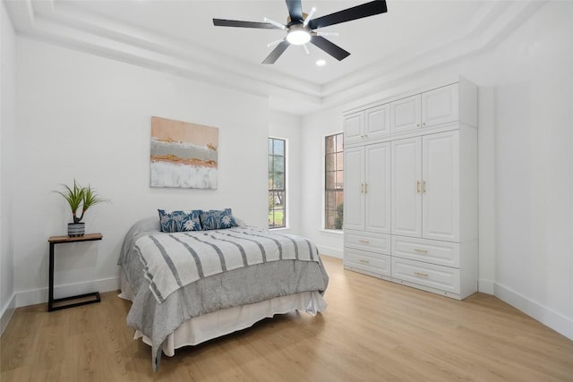 14904 Cordero Dr, Austin, TX 78717 - bedroom with a raised ceiling, light wood-style flooring, recessed lighting, baseboards, and a ceiling fan