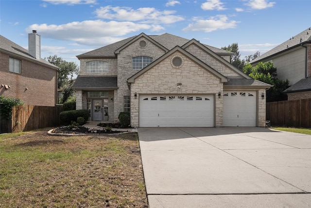 14904 Cordero Dr, Austin, TX 78717 - french country style house featuring concrete driveway, stone siding, an attached garage, and roof with shingles