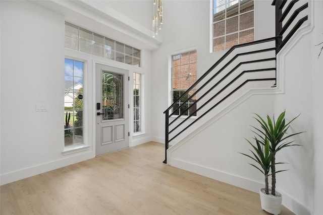 14904 Cordero Dr, Austin, TX 78717 - foyer featuring stairway, baseboards, healthy amount of natural light, wood finished floors, and a towering ceiling